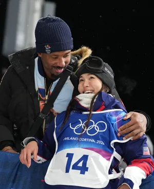 Chloe Kim of the United States with Cleveland Browns player Myles Garrett after her second run in the women's halfpipe final.