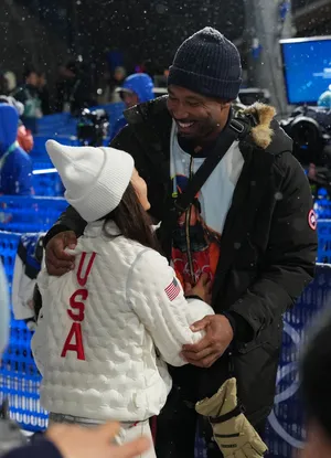 Cleveland Browns player Myles Garrett greets Chloe Kim of the United States after the women's halfpipe final.