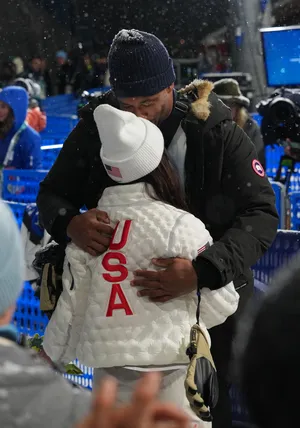 Cleveland Browns player Myles Garrett greets Chloe Kim of the United States after the women's halfpipe final.