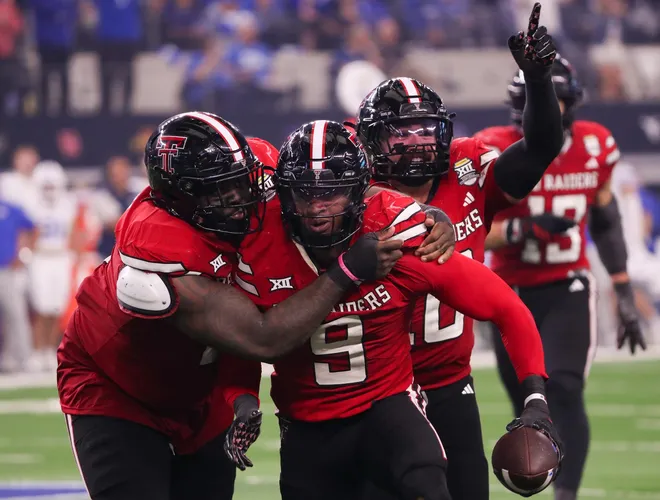 Texas Tech players Lee Hunter (left) and Jacob Rodriguez (back) celebrate Romello Height's fumble recover against BYU during the Big 12 Conference championship football game, Saturday, Nov. 6, 2025, at AT&T Stadium in Arlington.