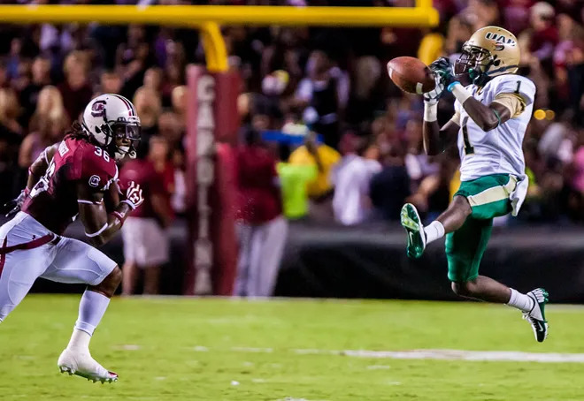 UAB Blazers wide receiver J.J. makes a reception as South Carolina Gamecocks safety D.J. Swearinger closes.
