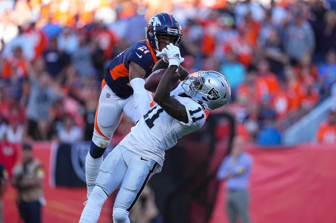 Las Vegas Raiders wide receiver Henry Ruggs III pulls in a reception past Denver Broncos cornerback Ronald Darby.