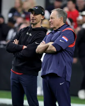 LAS VEGAS, NEVADA - DECEMBER 18: Special teams coordinator Cameron Achord (L) and head coach Bill Belichick of the New England Patriots watch players warm up before a game against the Las Vegas Raiders at Allegiant Stadium on December 18, 2022 in Las Vegas, Nevada. The Raiders defeated the Patriots 30-24. (Photo by Ethan Miller/Getty Images)