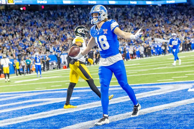 Dec 21, 2025; Detroit, Michigan, USA; Detroit Lions wide receiver Isaac Teslaa (18) scores a touchdown during the third quarter against the Pittsburgh Steelers at Ford Field. Mandatory Credit: David Reginek-Imagn Images