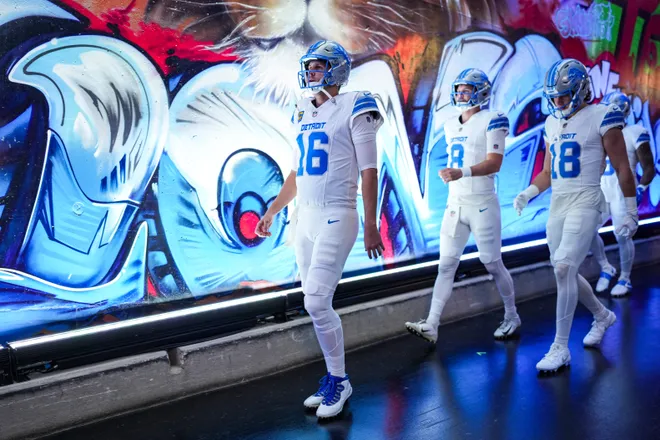 Detroit Lions quarterback Jared Goff walks down the tunnel with quarterback Kyle Allen (8) and wide receiver Isaac Teslaa (18) for warmups ahead of the Dallas Cowboys game at Ford Field in Detroit on Thursday, Dec. 4, 2025.