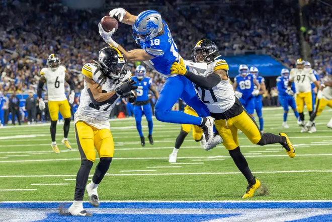 Dec 21, 2025; Detroit, Michigan, USA; Detroit Lions wide receiver Isaac Teslaa (18) scores a touchdown during the third quarter against the Pittsburgh Steelers at Ford Field. Mandatory Credit: David Reginek-Imagn Images