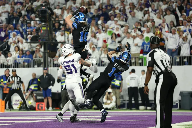 Dec 25, 2025; Minneapolis, Minnesota, USA; Detroit Lions wide receiver Isaac Teslaa (18) makes a catch for a touchdown defended by Minnesota Vikings linebacker Blake Cashman (51) in the second quarter at U.S. Bank Stadium. Mandatory Credit: Matt Krohn-Imagn Images