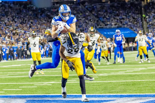 Dec 21, 2025; Detroit, Michigan, USA; Detroit Lions wide receiver Isaac Teslaa (18) scores a touchdown during the third quarter against the Pittsburgh Steelers at Ford Field. Mandatory Credit: David Reginek-Imagn Images