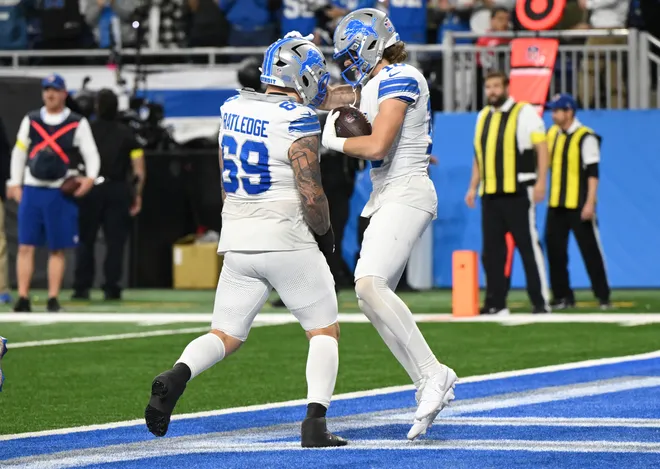 Dec 4, 2025; Detroit, Michigan, USA; Detroit Lions wide receiver Isaac Teslaa (18) celebrates with guard Tate Ratledge (69) after scoring a touchdown during the second half against the Dallas Cowboys at Ford Field. Mandatory Credit: Lon Horwedel-Imagn Images