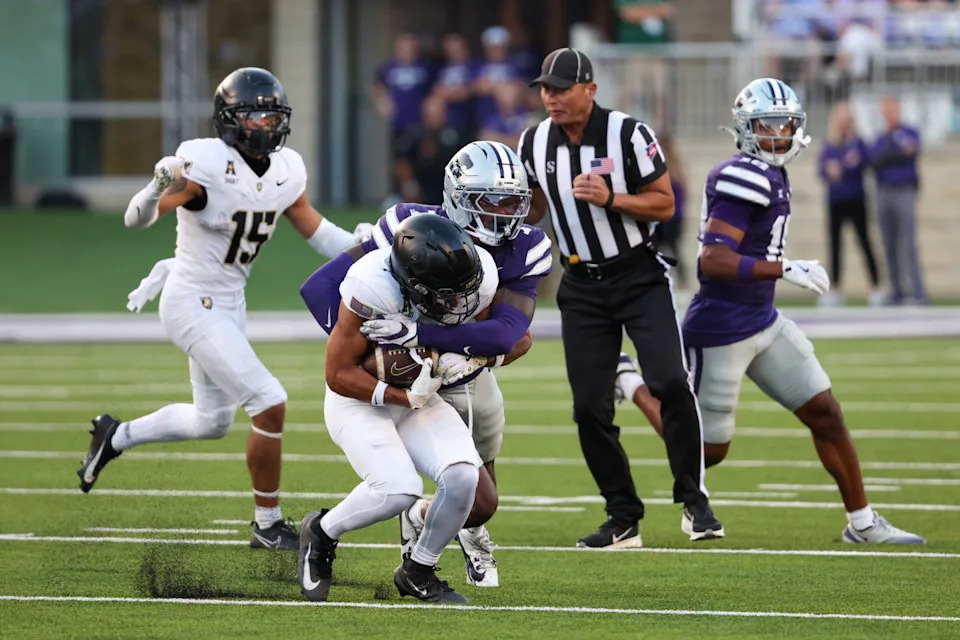 Sep 6, 2025; Manhattan, Kansas, USA; Army Black Knights wide receiver Samari Howard (27) is tackled by Kansas State Wildcats safety VJ Payne (7) during the third quarter at Bill Snyder Family Football Stadium. Scott Sewell-Imagn Images