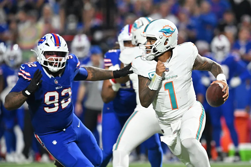 Sep 18, 2025; Orchard Park, New York, USA; Miami Dolphins quarterback Tua Tagovailoa (1) looks to pass against Buffalo Bills defensive tackle Daquan Jones (92) in the first half at Highmark Stadium. Mandatory Credit: Mark Konezny-Imagn Images