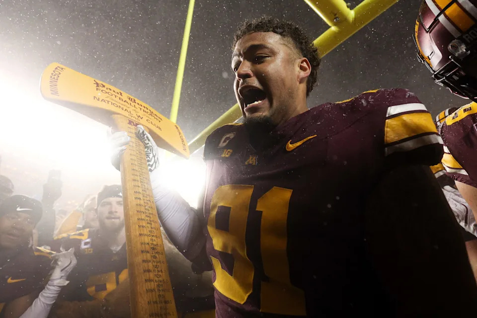 Nov 29, 2025; Minneapolis, Minnesota, USA; Minnesota Golden Gophers defensive lineman Deven Eastern (91) celebrates with Paul Bunyan’s Axe after the game against the Wisconsin Badgers at Huntington Bank Stadium. Mandatory Credit: Matt Krohn-Imagn Images