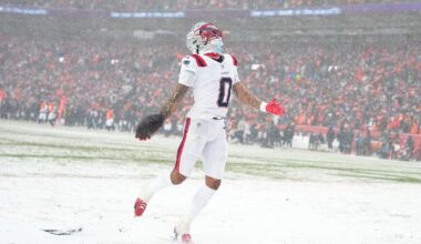 Christian Gonzalez celebrates in the snow after an interception that helped seal the Patriots’ victory in the AFC Championship game in Denver.