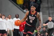 Texas Tech forward JT Toppin (15) dribbles up court during the first half of an NCAA college...