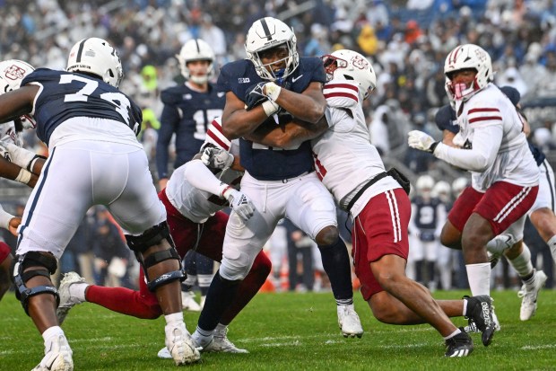 Penn State running back Kaytron Allen (13) breaks tackles on his way to score a touchdown during the first half against Massachusetts on Saturday, Oct. 14, 2023, in State College, Pa. (AP Photo/Barry Reeger)