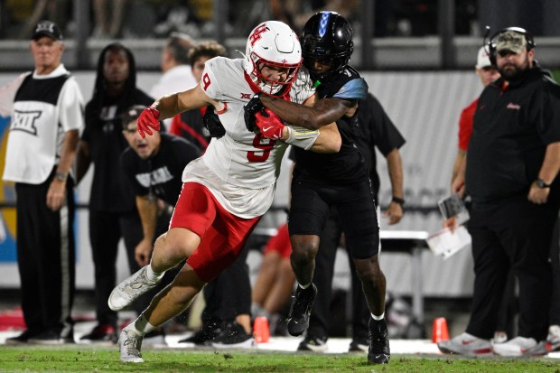 Houston tight end Tanner Koziol (9) is tackled by Central Florida defensive back Antione Jackson (7) after catching a pass during the second half of a game on Friday, Nov. 7, 2025, in Orlando, Fla. (AP Photo/Phelan M. Ebenhack)