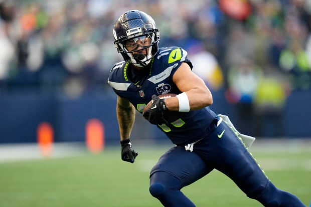 Seattle Seahawks wide receiver Jaxon Smith-Njigba (11) runs with the ball during the NFC Championship Game, Sunday, Jan. 25, 2026, in Seattle. (AP Photo/Ben VanHouten)