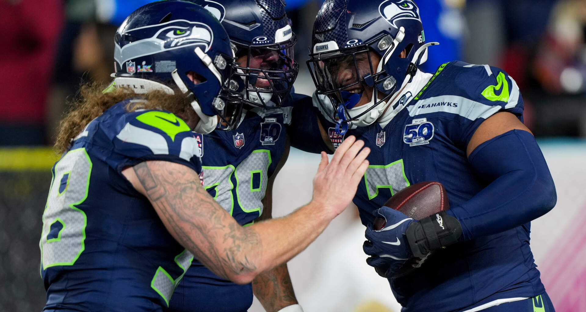 Seattle Seahawks linebacker Uchenna Nwosu, right, is congratulated by teammates after recovering a fumble and returning it for a touchdown during the second half of the NFL Super Bowl 60 football game against the New England Patriots, Sunday, Feb. 8, 2026, in Santa Clara, Calif. (Brynn Anderson/AP)