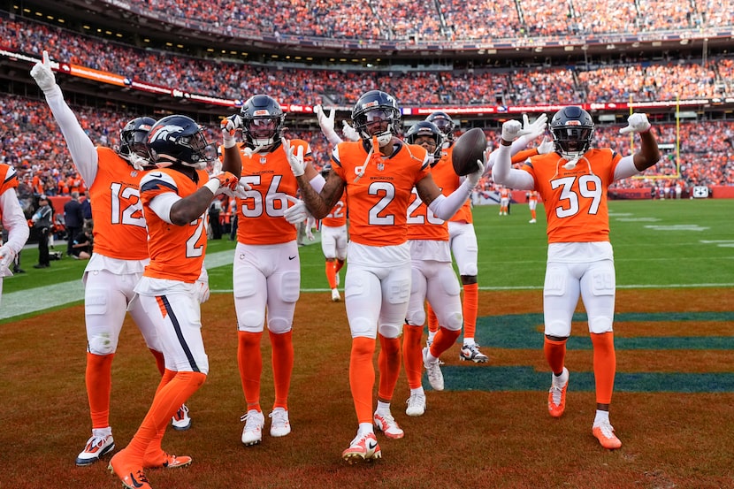 Denver Broncos cornerback Pat Surtain II (2) celebrates his interception with teammates...