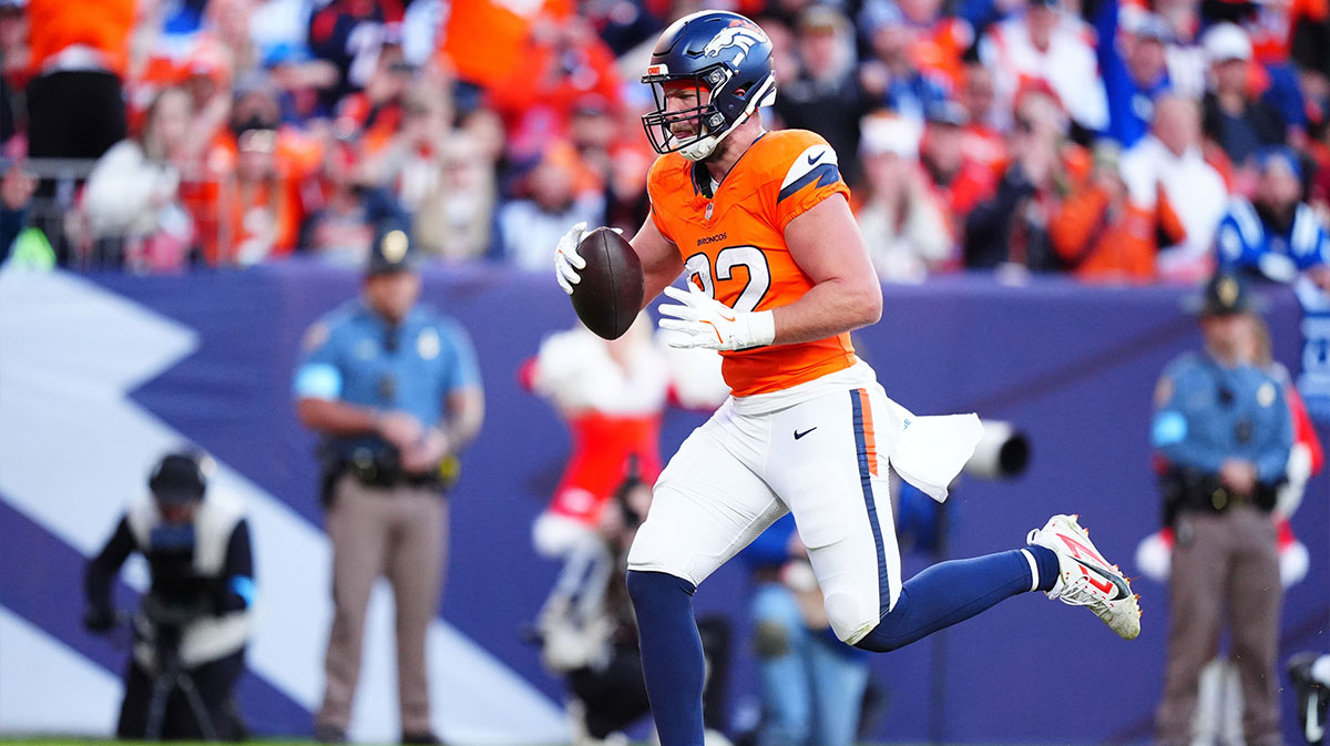 Dec 15, 2024; Denver, Colorado, USA; Denver Broncos tight end Adam Trautman (82) scores a touchdown against the Indianapolis Colts at Empower Field at Mile High. Mandatory Credit: Ron Chenoy-Imagn Images