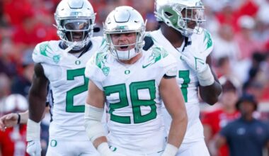 Oregon Ducks linebacker wearing No. 28 fires up teammates during a road game against a ranked opponent.