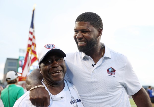 Hall of Fame inductee and former Bear Devin Hester, right, greets Bears equipment manager Tony Medlin before the Hall of Fame Game on Aug. 1, 2024, in Canton, Ohio. (John J. Kim/Chicago Tribune)