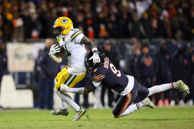 Chicago Bears safety Jaquan Brisker tackles Green Bay Packers wide receiver Jayden Reed during the fourth quarter of a NFC wild-card game at Soldier Field on Jan. 10, 2026 in Chicago. (Armando L. Sanchez/Chicago Tribune)