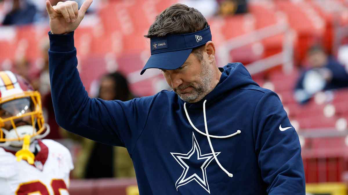 Dallas Cowboys head coach Brian Schottenheimer looks on during warmups before the game against the Washington Commanders at Northwest Stadium.
