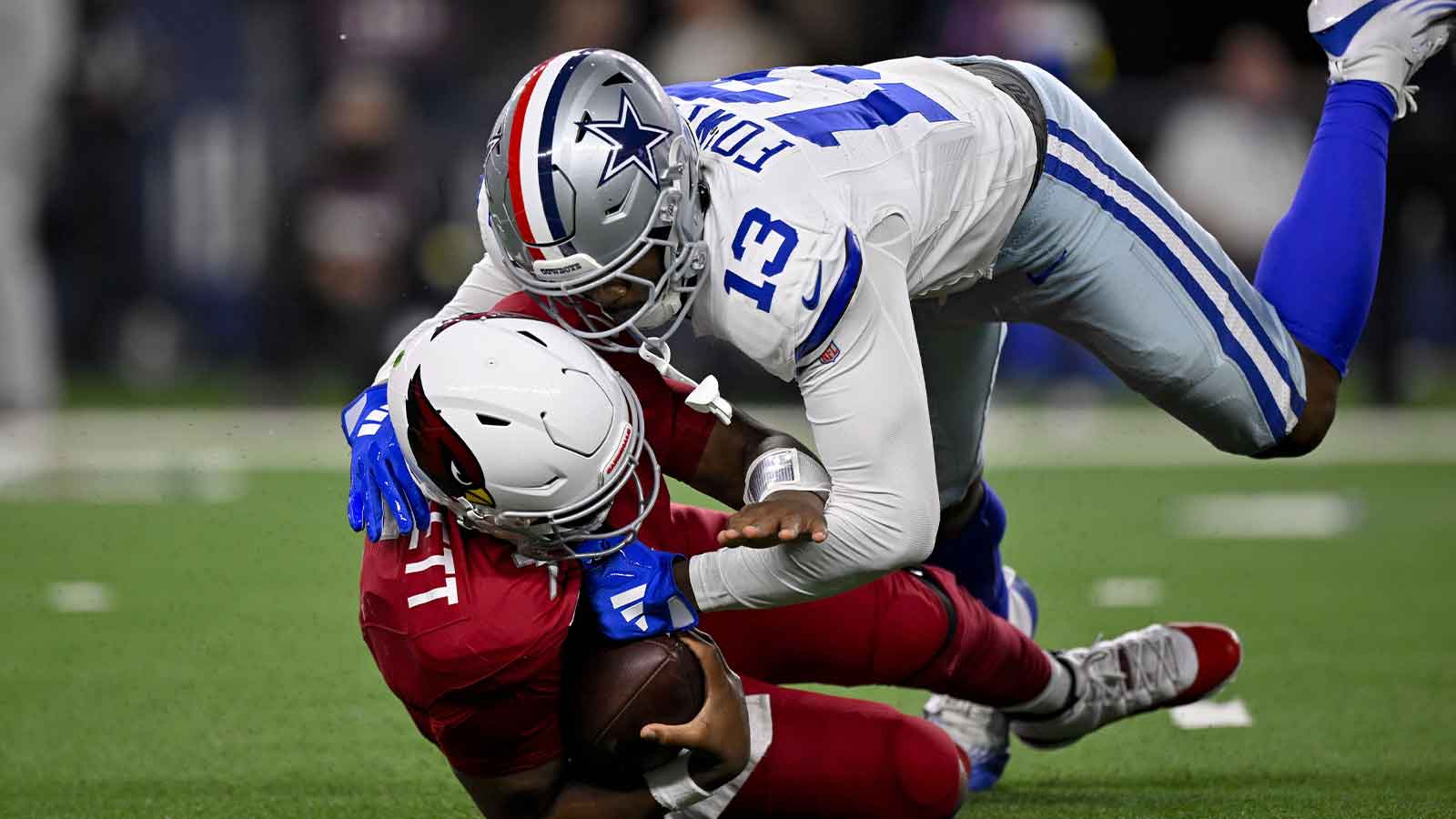 Dallas Cowboys defensive end Dante Fowler Jr. (13) sacks Arizona Cardinals quarterback Jacoby Brissett (7) during the game between the Dallas Cowboys and the Arizona Cardinals at AT&T Stadium.