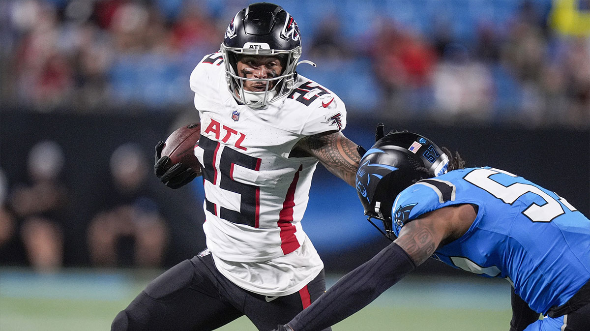 Atlanta Falcons running back Tyler Allgeier (25) stiff arms Carolina Panthers linebacker Claudin Cherelus (53) during the second half at Bank of America Stadium.