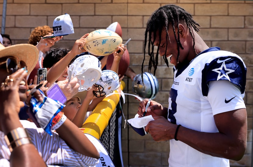 Dallas Cowboys wide receiver George Pickens (3) signs autographs for fans following training...