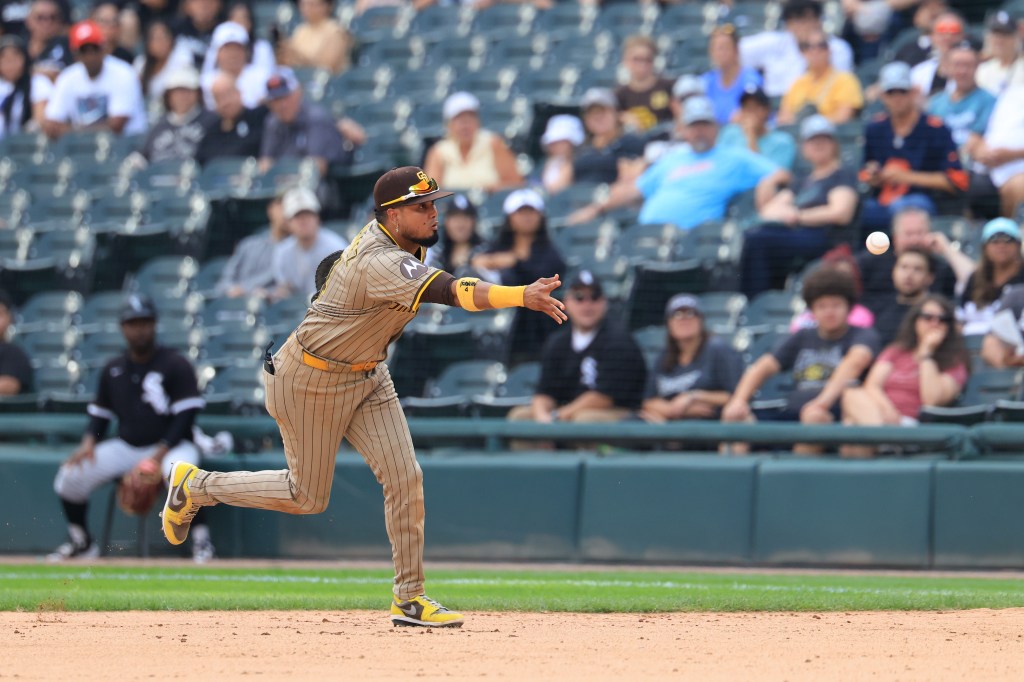 Luis Arraez #4 of the San Diego Padres throws the ball to first base during the ninth inning against the Chicago White Sox at Rate Field on September 21, 2025 in Chicago, Illinois.