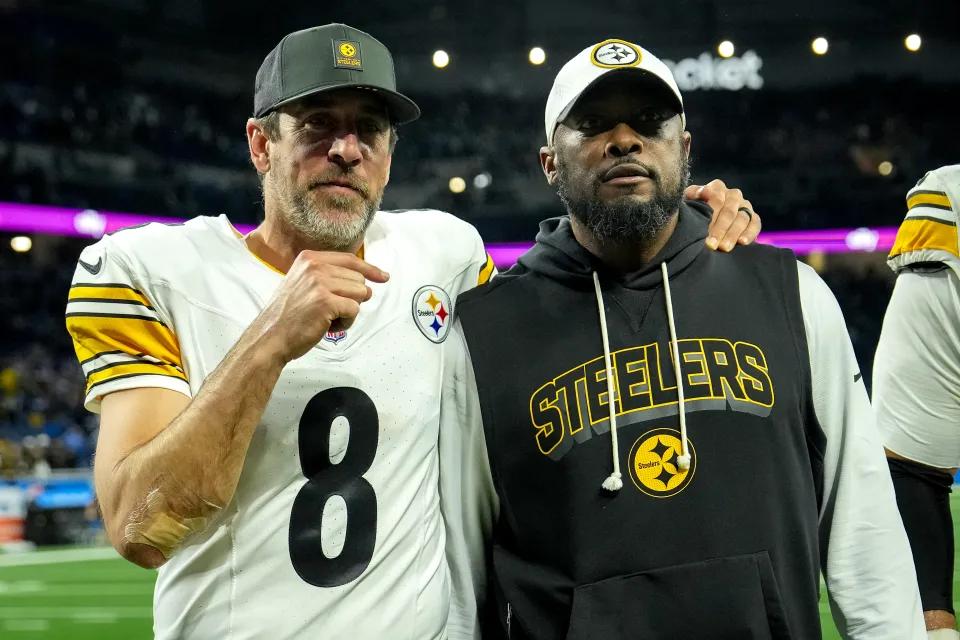 Head coach Mike Tomlin walks off the field with Aaron Rodgers #8 of the Pittsburgh Steelers after beating the Detroit Lions 29-24 at Ford Field