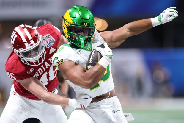 Kenyon Sadiq #18 of the Oregon Ducks is tackled by Isaiah Jones #46 of the Indiana Hoosiers during the first quarter in the 2025 College Football Playoff Semifinal at the Chick-fil-A Peach Bowl at Mercedes-Benz Stadium on Jan. 9, 2026, in Atlanta, Georgia. (Photo by Kevin C. Cox/Getty Images)