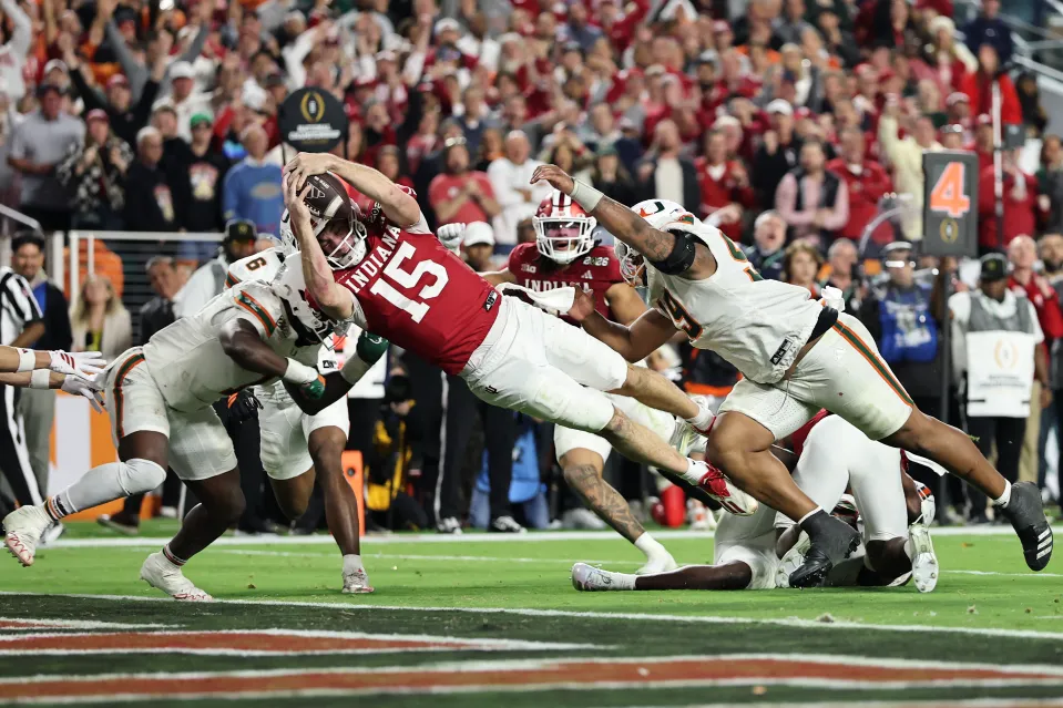 MIAMI GARDENS, FLORIDA - JANUARY 19: Fernando Mendoza #15 of the Indiana Hoosiers dives for a fourth quarter touchdown against the Miami Hurricanes in the 2026 College Football Playoff National Championship at Hard Rock Stadium on January 19, 2026 in Miami Gardens, Florida. (Photo by Carmen Mandato/Getty Images)
