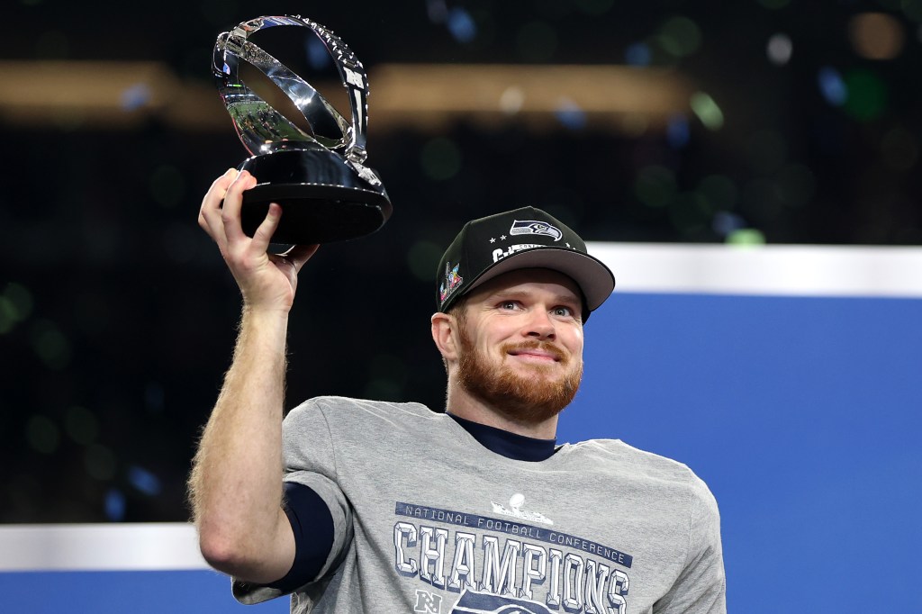 Sam Darnold celebrates with the George Halas Trophy after defeating the Los Angeles Rams 31-27 in the NFC Championship game at Lumen Field on January 25, 2026 in Seattle, Washington. 