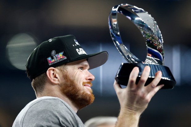 SEATTLE, WASHINGTON - JANUARY 25: Sam Darnold #14 of the Seattle Seahawks celebrates with the George Halas Trophy after defeating the Los Angeles Rams 31-27 in the NFC Championship game at Lumen Field on January 25, 2026 in Seattle, Washington. (Photo by Ronald Martinez/Getty Images)