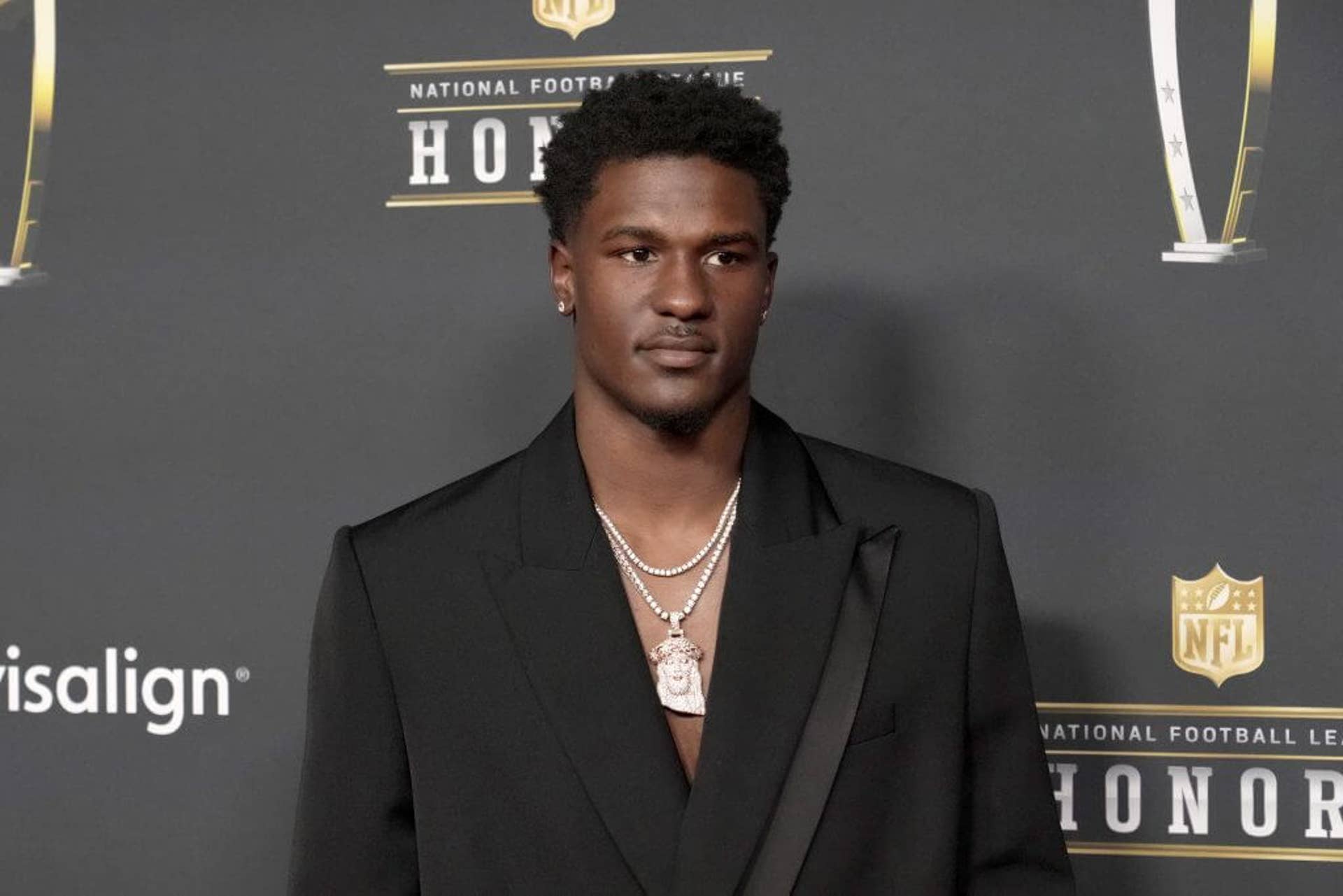 James Pearce Jr. poses in a black suit and Jesus chain outside the 15th Annual NFL Honors at Palace Of Fine Arts in San Francisco, Calif.