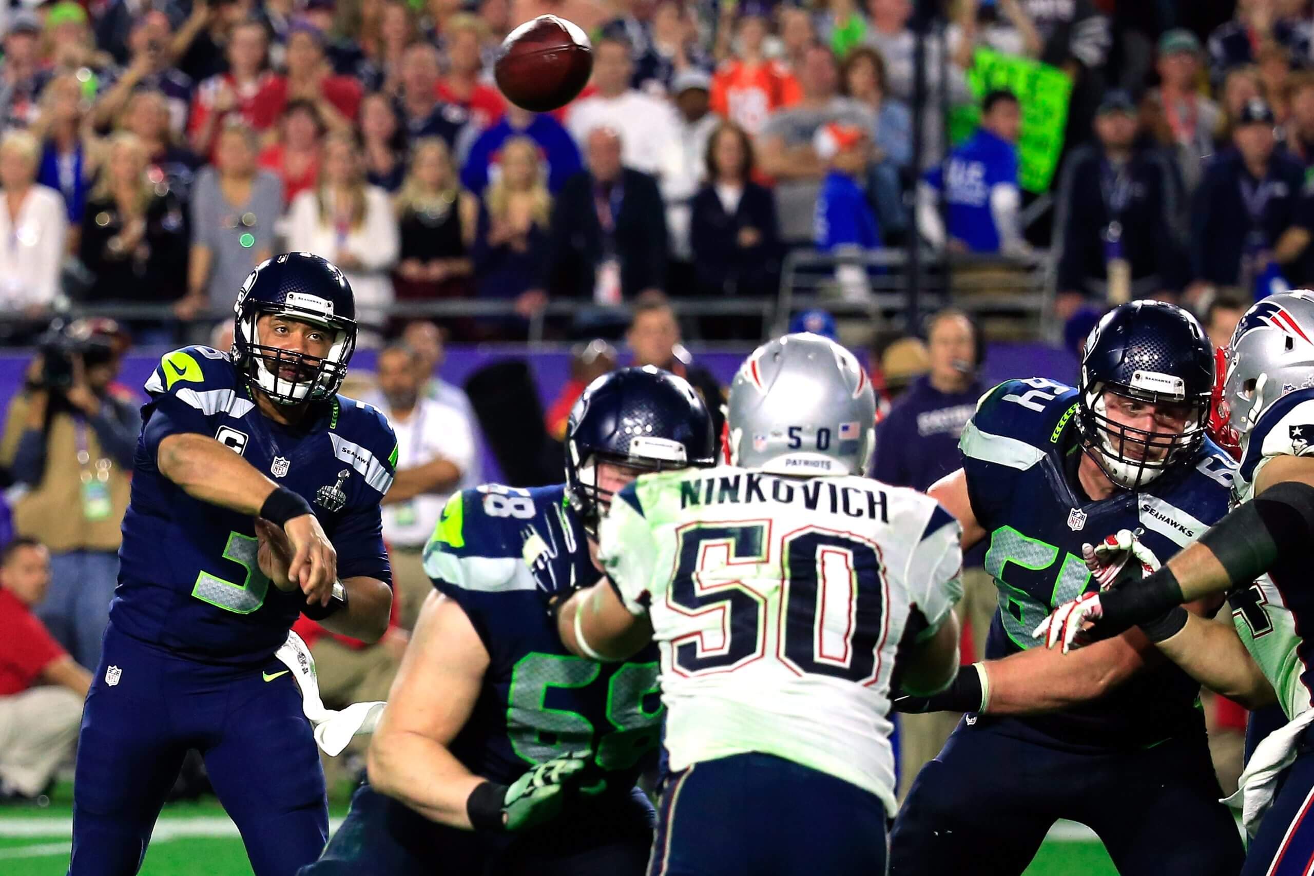 Russell Wilson #3 of the Seattle Seahawks has a pass intercepted by Malcolm Butler #21 of the New England Patriots