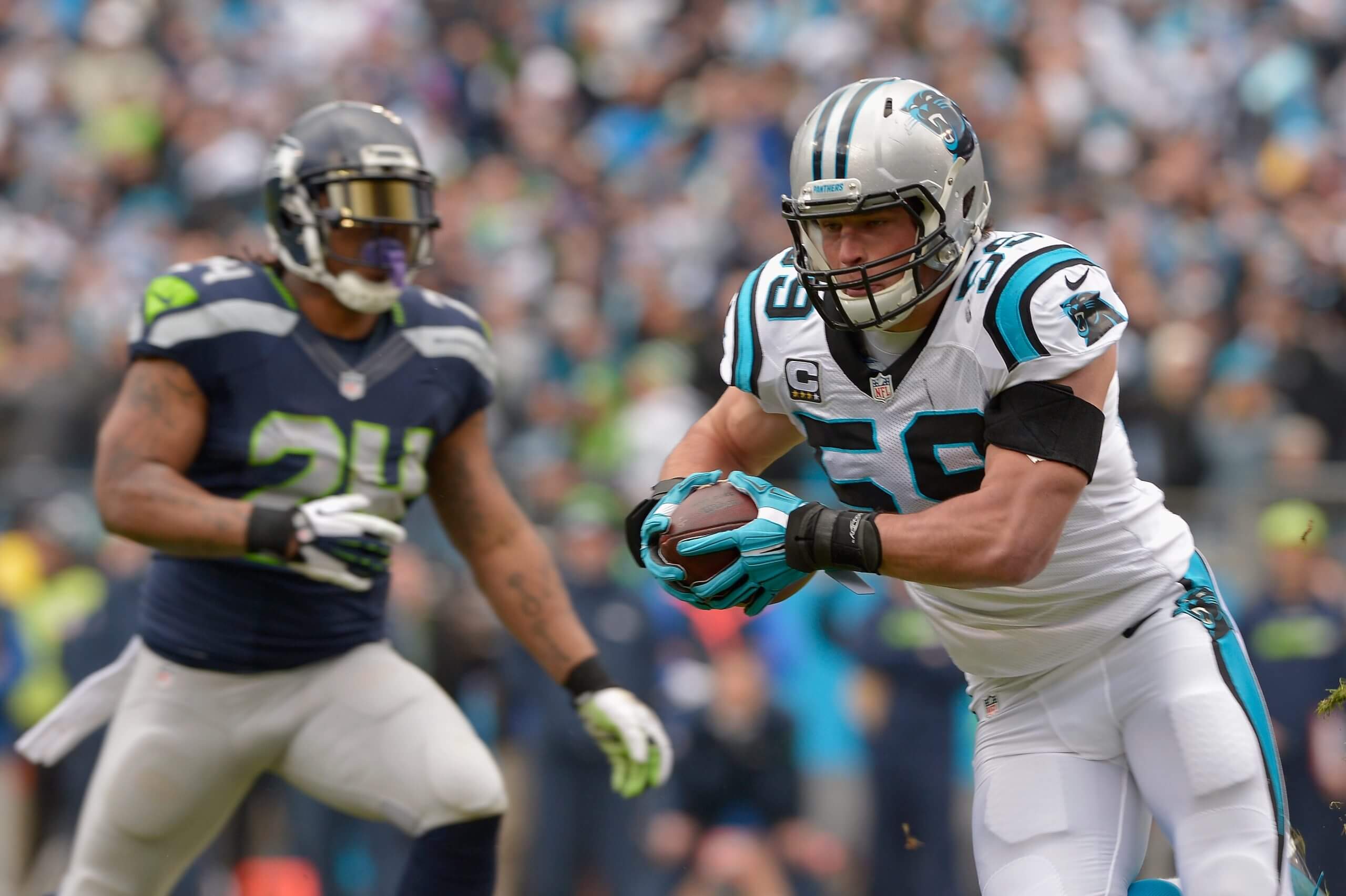 Carolina Panthers linebacker Luke Kuechly intercepts this pass intended for Seattle's Marshawn Lynch and returns it for a touchdown in the NFC divisional round playoff game on Jan. 17, 2016.