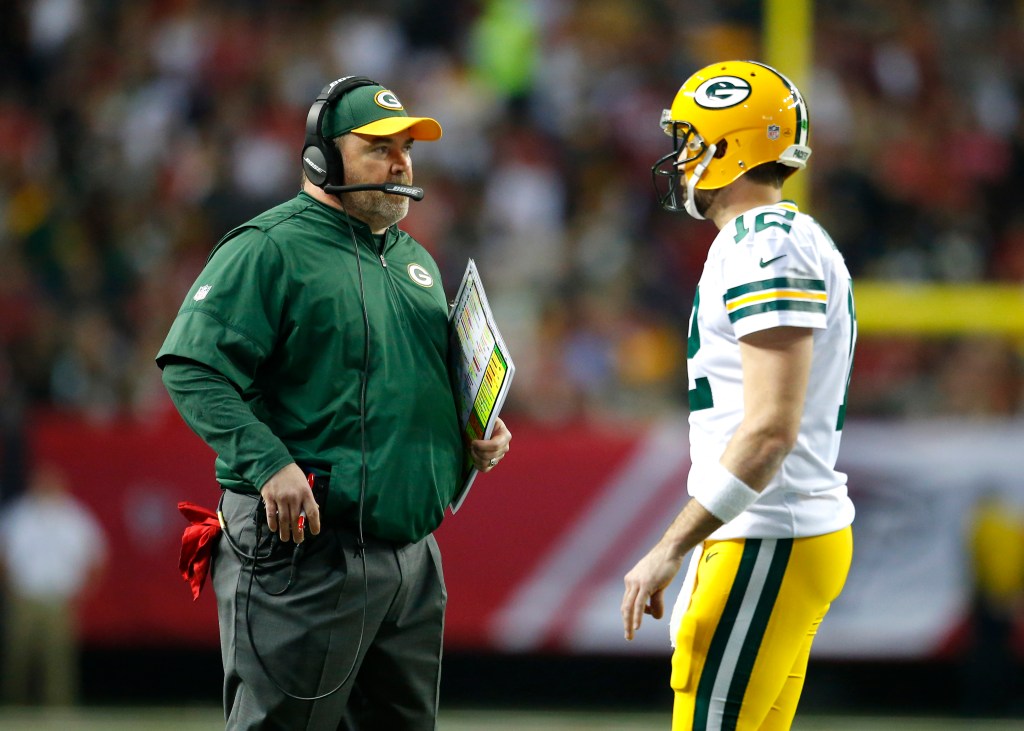 Mike McCarthy speaks with quarterback Aaron Rodgers (12) as he walks off the field in the second half of the NFC Championship game between the Green Bay Packers and Atlanta Falcons on January 22, 2017, at the Georgia Dome in Atlanta, GA. 