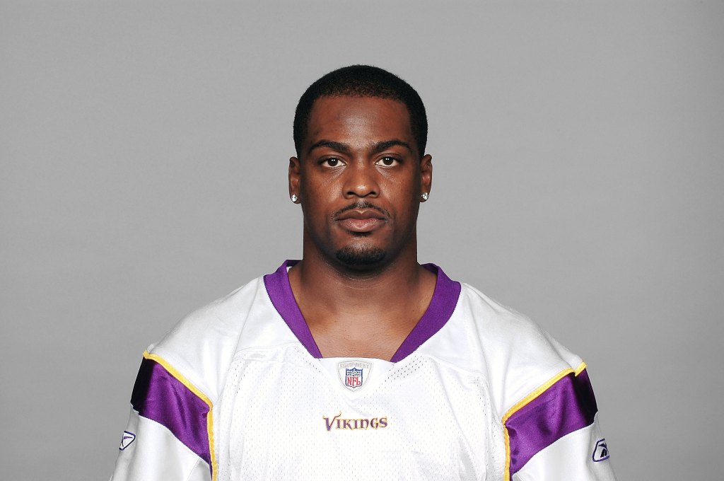 Headshot of a Minnesota Vikings player in a white jersey with purple and yellow trim.
