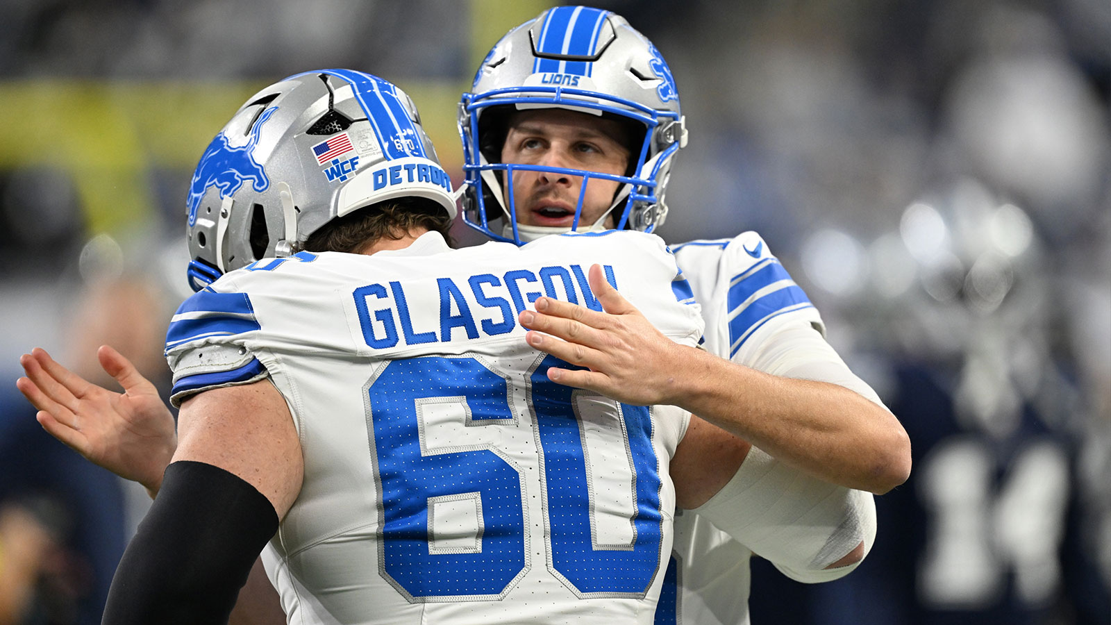 Detroit Lions quarterback Jared Goff (16) greets center Graham Glasgow (60) during warm ups before a game against the Dallas Cowboys at Ford Field.