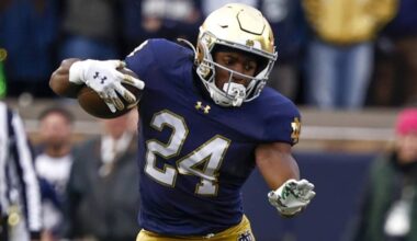 Jadarian Price cuts laterally with the football, showcasing agility and contact balance for Notre Dame.