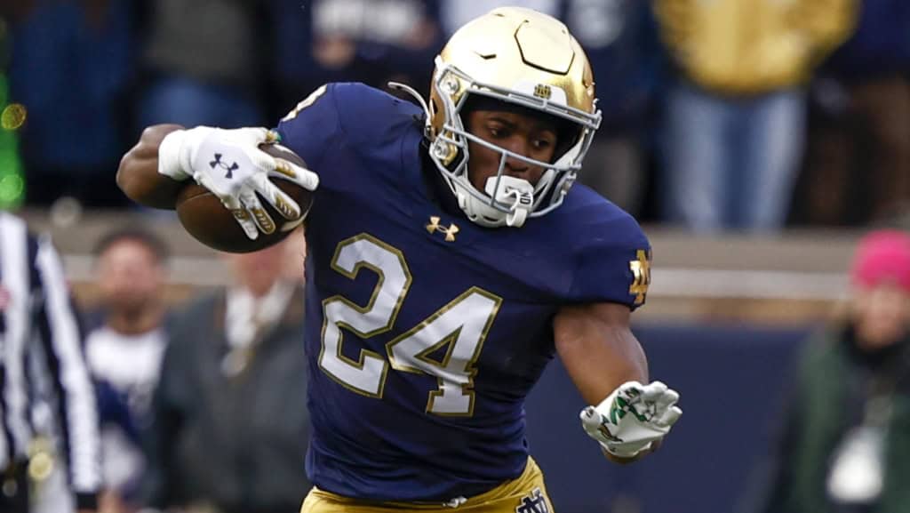 Jadarian Price cuts laterally with the football, showcasing agility and contact balance for Notre Dame.