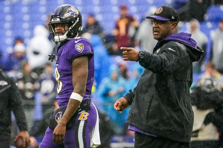 Baltimore Ravens quarterback coach Tee Martin walks near quarterback Lamar Jackson (8) during warmups before the game against the Los Angeles Rams at M&T Bank Stadium on Sunday, Dec. 10, 2023.