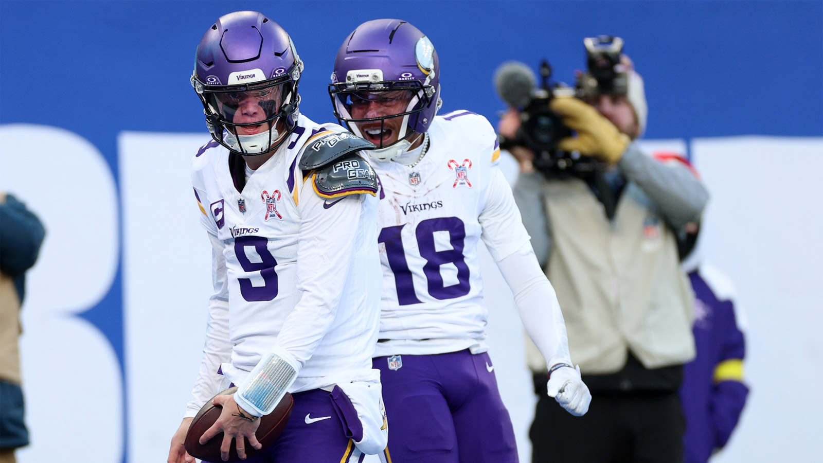 Minnesota Vikings quarterback J.J. McCarthy (9) reacts with wide receiver Justin Jefferson (18) after rushing for a touchdown against the New York Giants during the first half at MetLife Stadium.