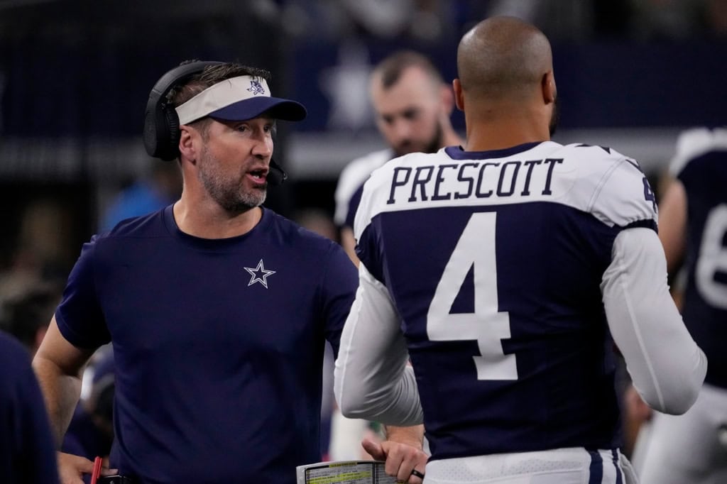 Cowboys 2026 Draft: Day 3 Quarterbacks Built for Schottenheimer Dallas Cowboys quarterback Dak Prescott speaks with his head coach on the sideline during an NFL game, wearing his #4 jersey.