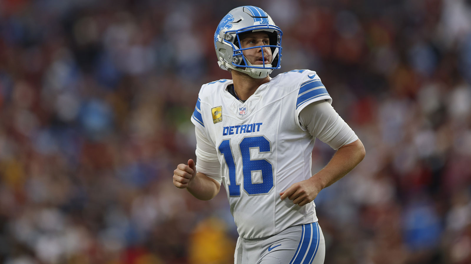 Detroit Lions quarterback Jared Goff (16) runs downfield during the first quarter against the Washington Commanders at Northwest Stadium.