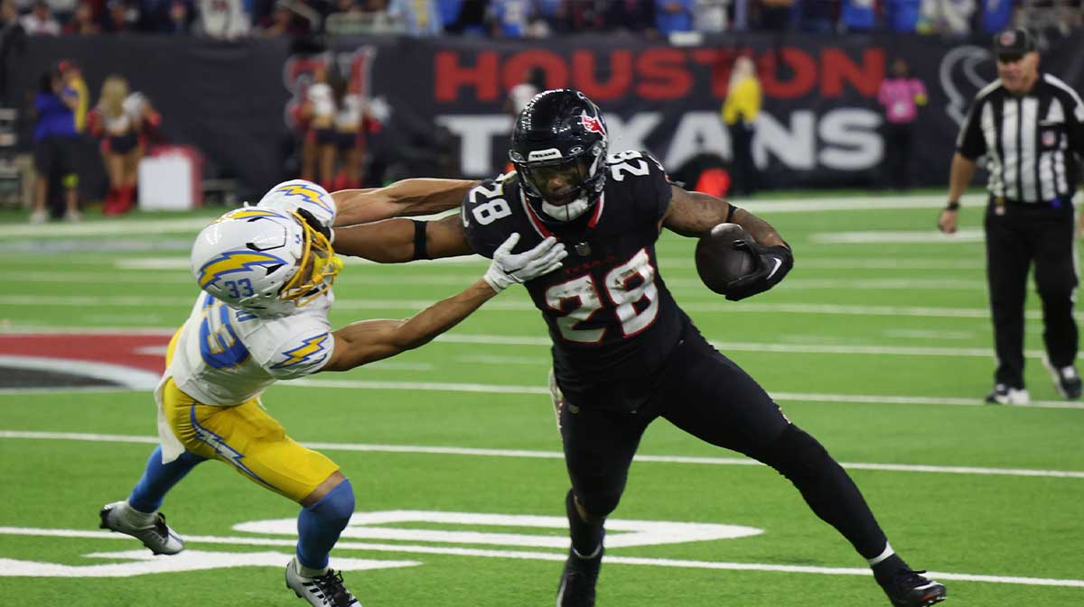 Los Angeles Chargers defensive back Deane Leonard (33) reaches for Houston Texans running back Joe Mixon (28) in the fourth quarter in an AFC wild card game at NRG Stadium.